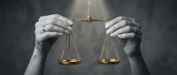 Hands holding golden scales of justice against dark background symbolizing law, legal system, fairness, court proceedings and judicial balance.