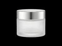 Frosted glass cosmetic jar with silver metallic lid, isolated on transparent background, ready for beauty product packaging design, skincare branding, print-on-demand labels, and e-commerce mockups.
