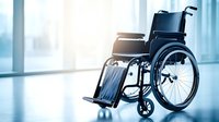 Empty wheelchair in bright hospital corridor with sunlight through windows, highlighting accessibility and medical care themes in modern healthcare facility.