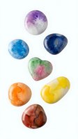 Polished gemstones in assorted colors including amethyst, blue topaz, aventurine, citrine and red jasper isolated on white background, ready for design use.