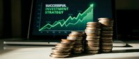 Stacked coins in front of laptop displaying successful investment strategy with upward trending green arrow graph on screen.