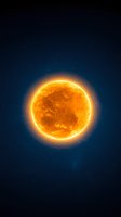 Glowing orange sun with detailed surface texture against deep blue space background with distant stars, creating dramatic celestial atmosphere.