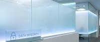 Modern office reception desk with data integrity security display and glass panels in clean corporate interior with blue lighting accents and professional design.