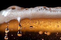 Beer with condensation droplets and foam head against dark background, perfect for beverage advertising and hospitality design projects.