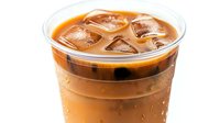 Refreshing iced coffee drink with condensation drops on plastic cup against white background, cold brew coffee with ice cubes floating on top.