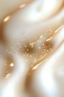 Luxurious cream and gold abstract background with flowing waves, sparkling droplets and light bokeh effects creating elegant cosmetic atmosphere.