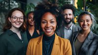 Diverse business team with African American woman in yellow blazer smiling confidently, colleagues standing behind in modern office environment.