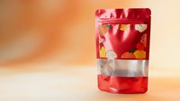 Red metallic foil pouch packaging with transparent window displaying colorful contents on warm gradient background for product branding and marketing.