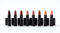 Collection of luxury lipsticks in various shades from deep burgundy to coral pink arranged in row on white background for cosmetic branding.