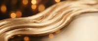 Flowing golden liquid metal waves with warm bokeh lights creating elegant abstract background for luxury design and premium branding projects.