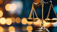 Golden scales of justice with warm bokeh lights creating professional legal atmosphere for law firm branding and judicial concepts.