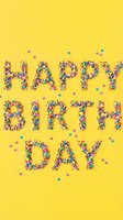 Happy Birthday text made of colorful candy sprinkles on bright yellow background with confetti, festive celebration greeting card concept.