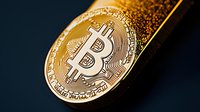 Golden cryptocurrency coin with detailed circuit pattern on dark background showing digital currency wealth and financial technology concept.