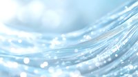 Ethereal light blue waves with glowing particles and bokeh effects create dreamy abstract background with soft flowing curves and luminous highlights.