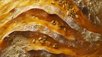 Fresh baked golden brown bread crust with sesame seeds, close up view showing texture and layersisanal baking detail.