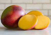 Fresh ripe mango fruit with bright yellow flesh slices on white background, closeup view showing juicy tropical fruit texture and vibrant colors.