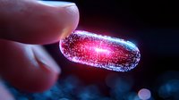 Glowing red pill capsule held between fingers against dark background, illuminated with magical light effect creating futuristic pharmaceutical concept.