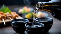 Pouring sake into traditional black ceramic cups with Japanese food in background, dramatic lighting captures liquid stream and dining atmosphere.