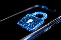 Glowing blue digital padlock icon on smartphone screen with sparkle effect and dark background represents cybersecurity and data protection concept.