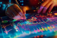 Financial analyst working with colorful stock market data visualization on digital screen, hand marking trading chart patterns in vibrant neon lighting atmosphere.