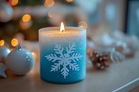 Glowing winter candle with snowflake design and festive bokeh lights in background, white ornament and pinecone create cozy holiday atmosphere.
