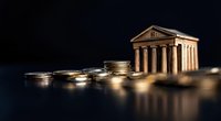 Classical bank building with golden coins stacked in foreground representing financial growth, investment planning and wealth management concepts.