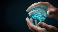 Protective hands surrounding glowing digital brain hologram representing mental health care, neuroscience research and cognitive protection concepts.