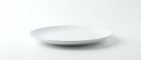 Empty white ceramic plate isolated on white background, ready for food photography, product mockups, and design compositions.