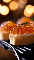 Red caviar canape with cream cheese on toasted bread against blurred golden bokeh lights, garnished with fresh herbs. Luxurious appetizer for festive dining.