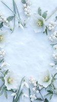 White winter floral frame with hellebore flowers and berries on snow background for holiday greeting cards and seasonal design projects.