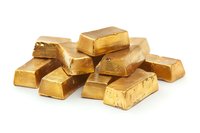 Stack of shiny gold bars on white background, precious metal bullion ingots showing wealth, luxury and financial investment concept. Isolated object.
