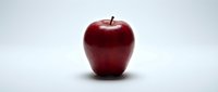 Fresh red apple with stem isolated on white background, suitable for healthy eating, nutrition, and food design projects.