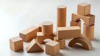 Natural wooden building blocks set with geometric shapes including cylinders cubes triangles and arches on neutral background for educational play.