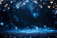 Glowing heart lights and sparkles against dark blue background with bokeh effect creates magical romantic atmosphere for Valentine's Day or wedding design.