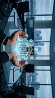 Businessman hands protecting digital holographic house model with network connections in modern office environment for real estate technology concepts.