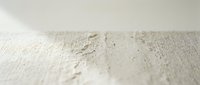 Textured white canvas surface with paint splatters and artistic brush strokes for creative projects and backgrounds.