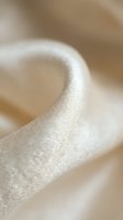 Soft white silk ribbon with delicate shimmering texture flowing gracefully in gentle curves, luxury fabric material for wedding decoration and crafting projects.