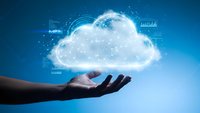 Hand holding glowing cloud with digital data streams and network connections representing cloud computing technology and data storage solutions.