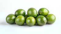 Fresh whole green limes arranged in row on white background, showing natural texture and vibrant color. Isolated food photography for culinary and cocktail designs.