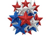 Festive cluster of red, white, and blue star ornaments hanging together on white background, isolated decoration for holiday displays, greeting cards, and seasonal marketing materials.