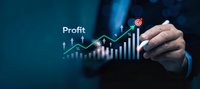 Businessman hand drawing upward profit growth chart with glowing digital interface showing financial success and business analytics on dark blue background.