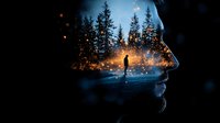 Surreal double exposure portrait combining male silhouette with night forest scene, glowing particles and bokeh lights creating magical atmospheric mood.