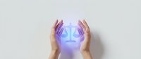 Hands protecting glowing justice scales symbol representing legal protection, law firm services, and attorney consultation for business and personal rights.