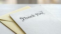 Thank you card with yellow envelope on white wooden surface, elegant stationery for gratitude, appreciation, and heartfelt messages.