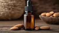 Amber glass dropper bottle with almond oil on rustic wooden table surrounded by fresh almonds for natural skincare and aromatherapy treatments.