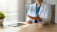 Female doctor in white coat displaying holographic patient health data interface with vital signs, heart rate and sleep metrics in modern clinic.