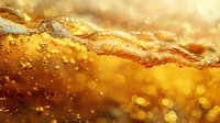 Golden liquid wave with bubbles and foam against shimmering bokeh background, creating dynamic motion and luxurious amber glow.