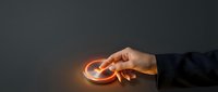 Close-up of hand holding glowing circular light orb against dark background, representing innovation, energy, ideas, and technology concepts for business and creative projects.