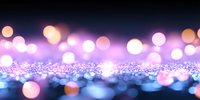 Dreamy pink and blue bokeh lights with glitter surface creating magical atmosphere, soft focus abstract background for festive designs and celebrations.