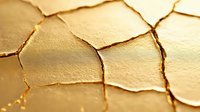 Cracked dry earth texture in golden sunlight creating natural abstract pattern of drought and environmental damage. Macro photography reveals intricate details.